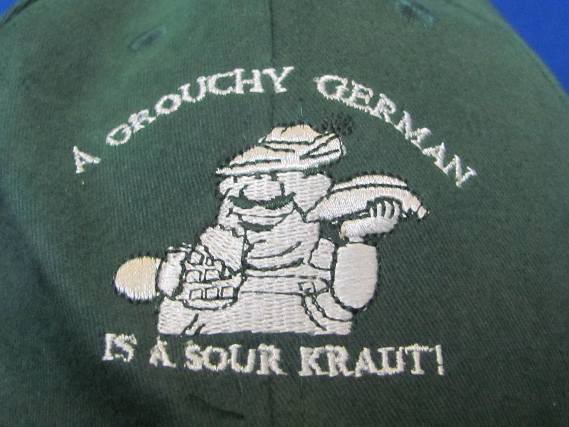 2 Caps: “If I only had a brain” & “A Grouchy German is a Sour Kraut” - Good condition