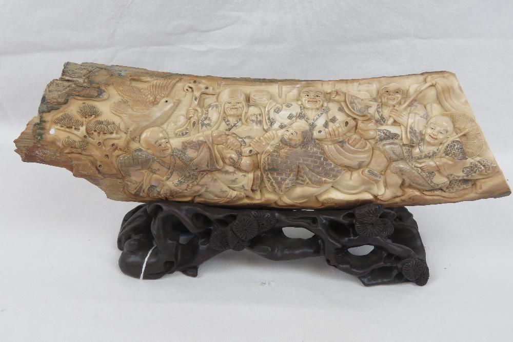 A carved segment of Woolly Mammoth tusk depicting six figures