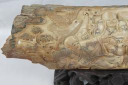 A carved segment of Woolly Mammoth tusk depicting six figures