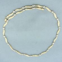 17 Inch Two Tone Alternating Swirl And Box Design Necklace In 14k Yellow And White Gold