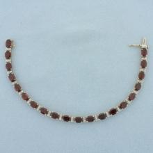 Oval Cut Garnet And Diamond Tennis Bracelet In 14k Yellow Gold