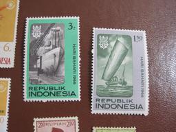 Lot of colorful Indonesia postage stamps, many of them unused