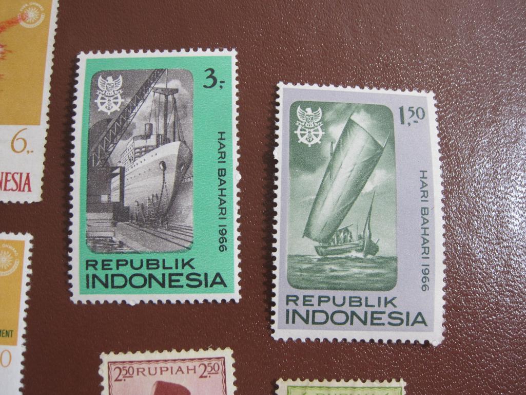 Lot of colorful Indonesia postage stamps, many of them unused