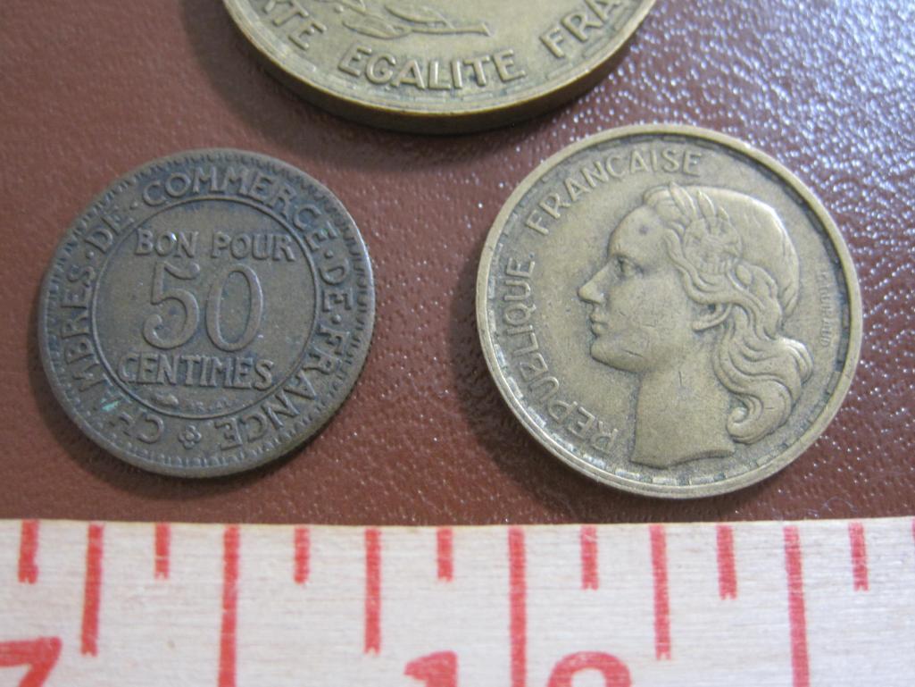 Three French coins: one 1923 50 centimes, one 1951 10 francs and one 1953 50 francs