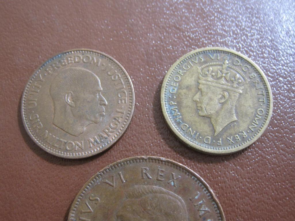 one 1938 British West Africa 6 pence, one 1964 Sierra Leone 1/2 cent and one bronze 1942 South