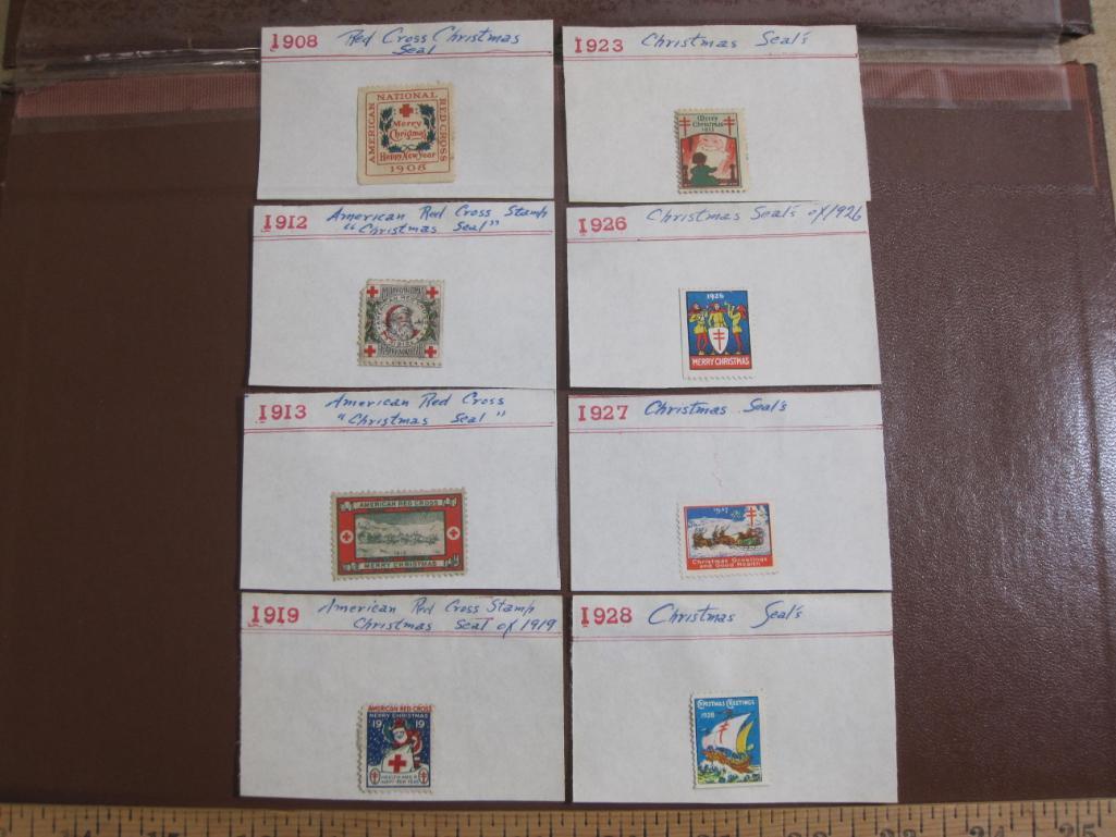 Eight early 1900s (1900-1930) Christmas Seals hinged to display cards