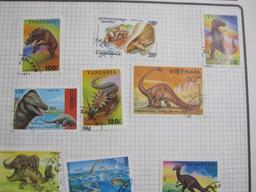 3 ring binder containing 3 pages of mounted cancelled dinosaur stamps from various countries and