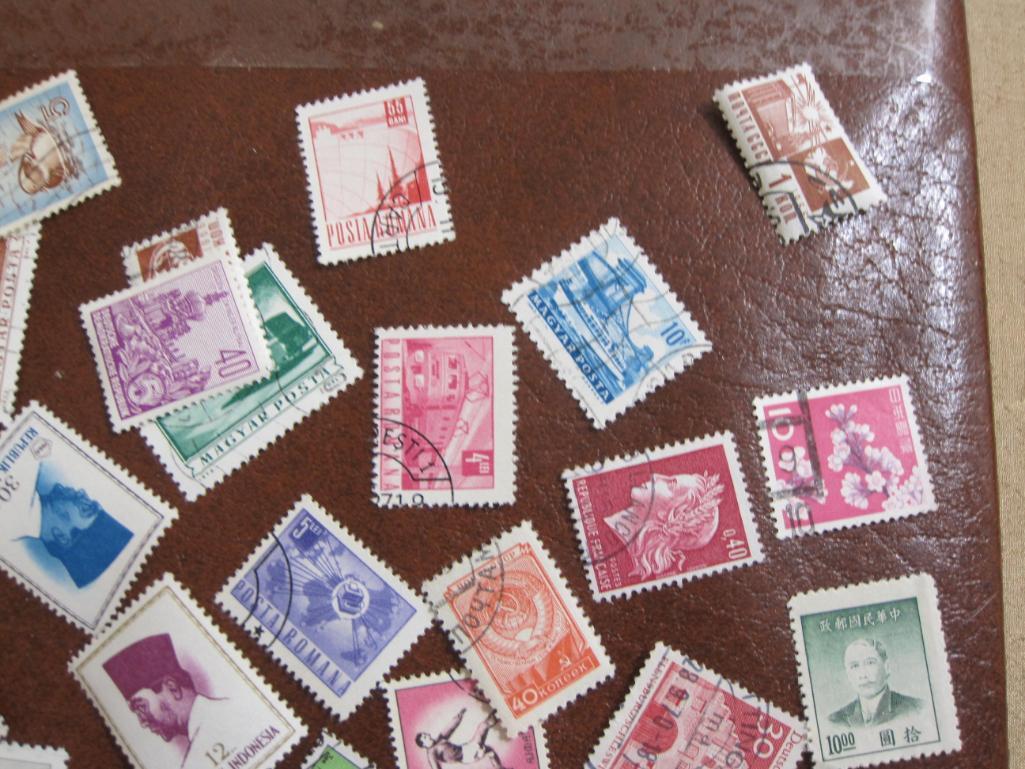 Lot of 60+ assorted cancelled foreign postage stamps from various countries inlcuding Spain,