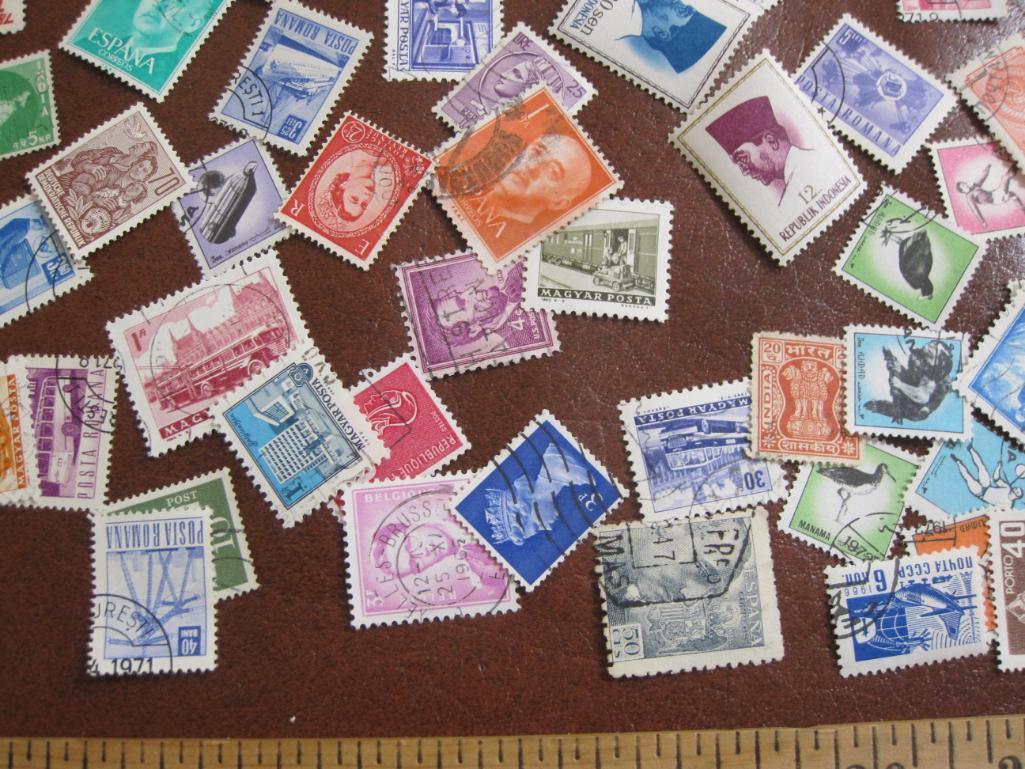 Lot of 60+ assorted cancelled foreign postage stamps from various countries inlcuding Spain,