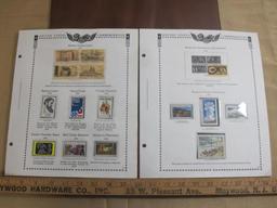 Two completed stamp collecting album pages printed by Minkus Publications; includes thirteen mounted