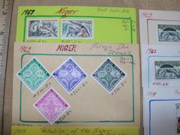 Lot of 20 1920s to 1960s Niger postage stamps. Six are loose. The rest are attached to small pieces