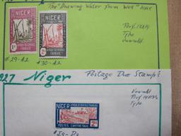 Lot of 20 1920s to 1960s Niger postage stamps. Six are loose. The rest are attached to small pieces