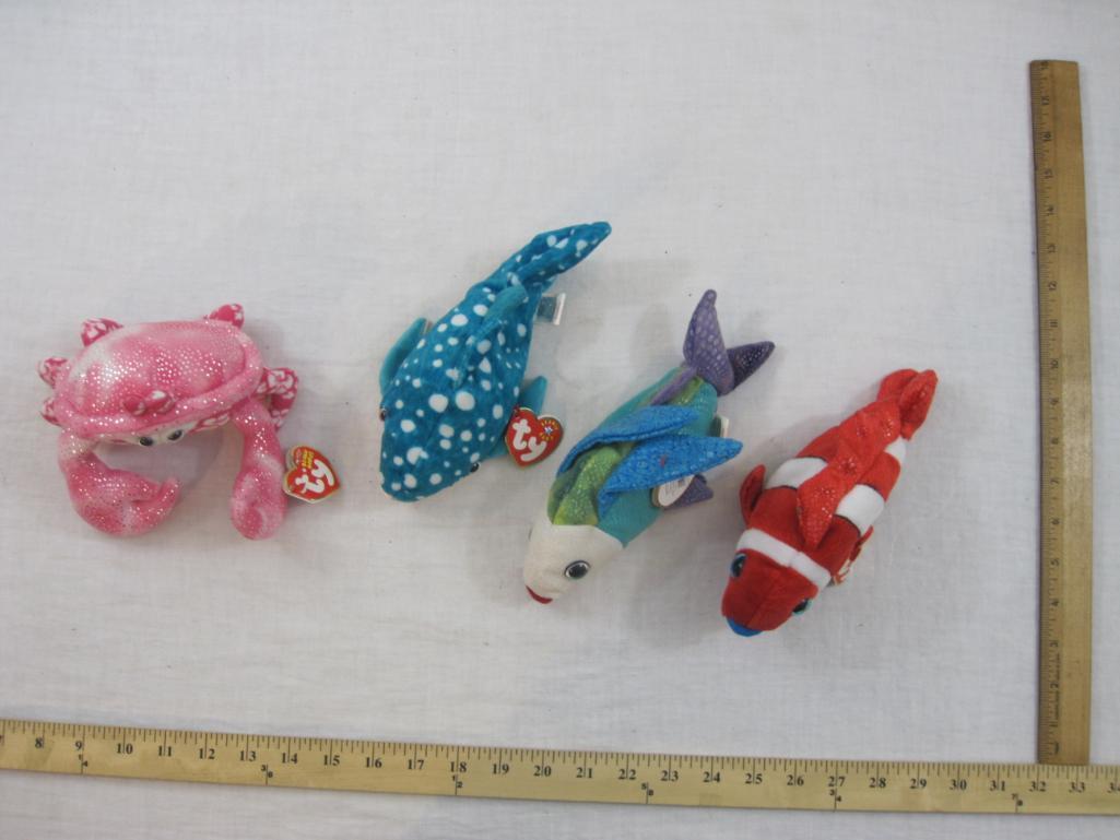 Four TY Beanie Babies including Propeller, Jester, Poseidon, and Sunburst, all tags included and