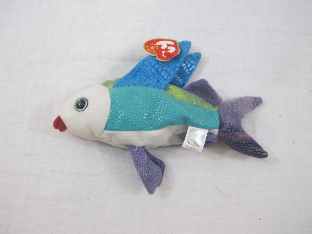 Four TY Beanie Babies including Propeller, Jester, Poseidon, and Sunburst, all tags included and