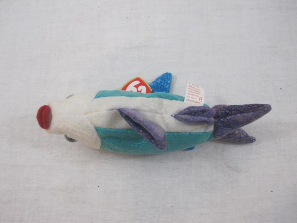 Four TY Beanie Babies including Propeller, Jester, Poseidon, and Sunburst, all tags included and