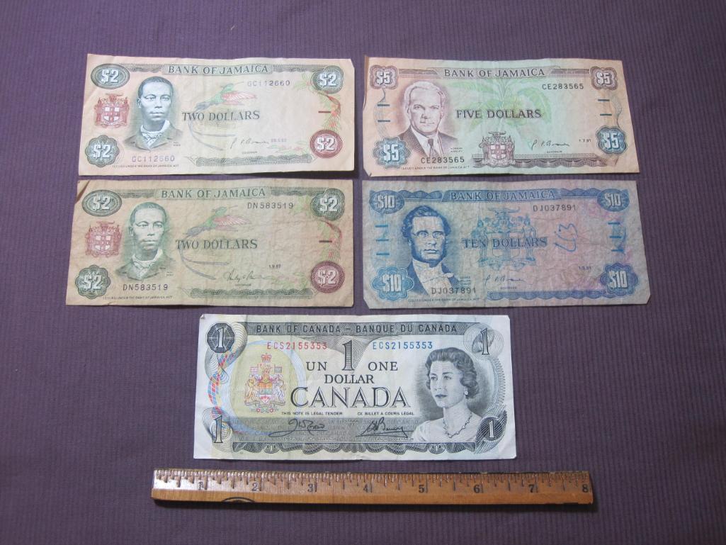 Four Bank of Jamaica pieces of paper currency (2 $2, $5 and $10) and 1 Bank of Canada $1 note