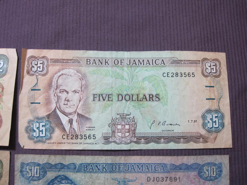 Four Bank of Jamaica pieces of paper currency (2 $2, $5 and $10) and 1 Bank of Canada $1 note