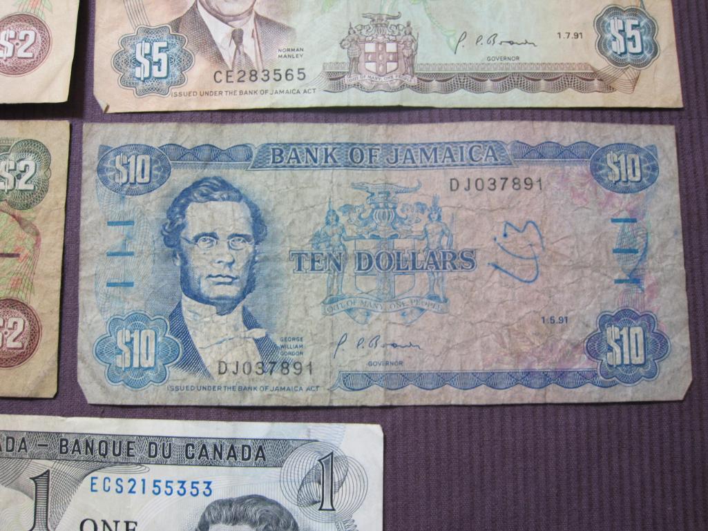 Four Bank of Jamaica pieces of paper currency (2 $2, $5 and $10) and 1 Bank of Canada $1 note