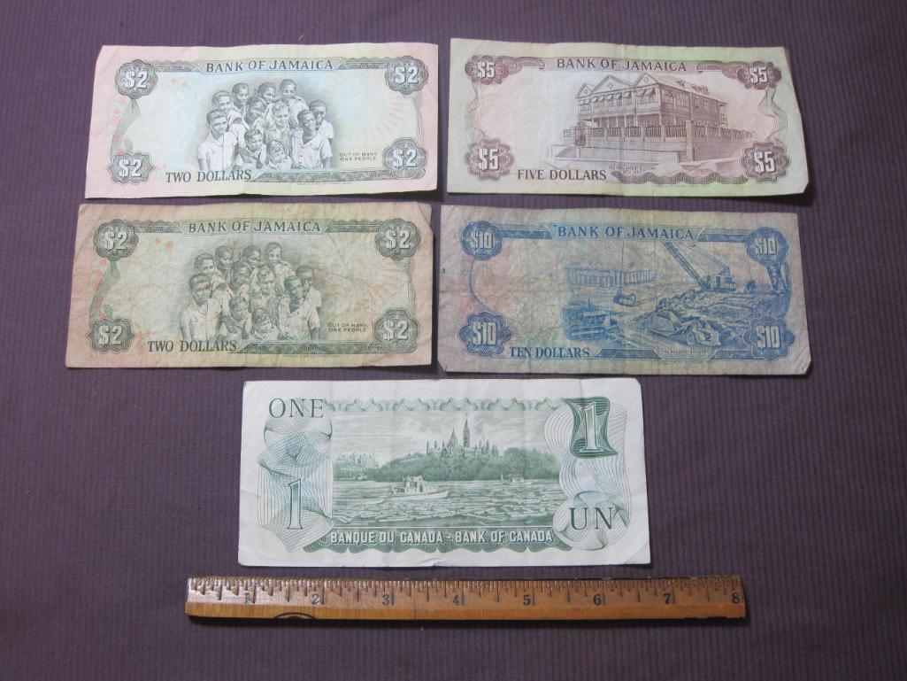 Four Bank of Jamaica pieces of paper currency (2 $2, $5 and $10) and 1 Bank of Canada $1 note