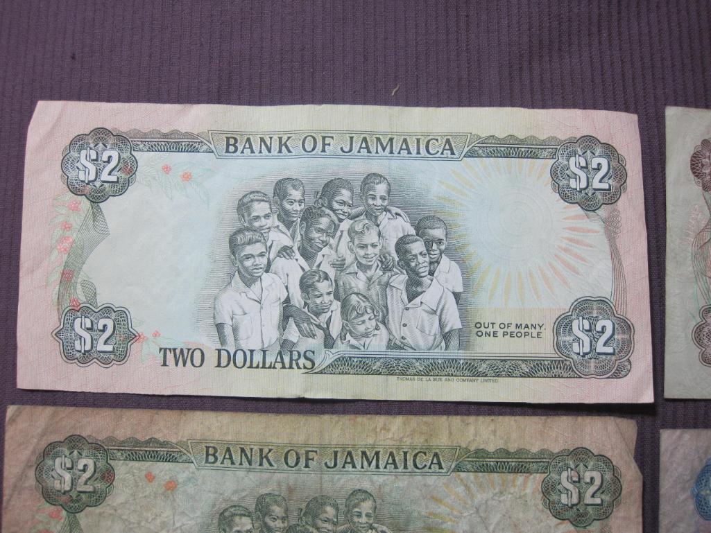 Four Bank of Jamaica pieces of paper currency (2 $2, $5 and $10) and 1 Bank of Canada $1 note