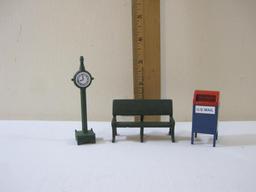 Three Department 56 Train/Christmas Display Accessories including clock, park bench, and US Mail