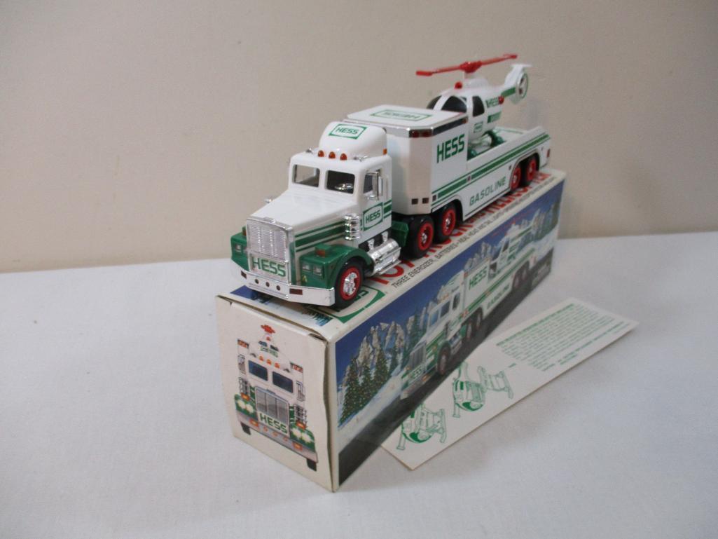 Two 1990s Hess Trucks including 1995 Toy Truck and Helicopter and 1997 Toy Truck and Racers, in