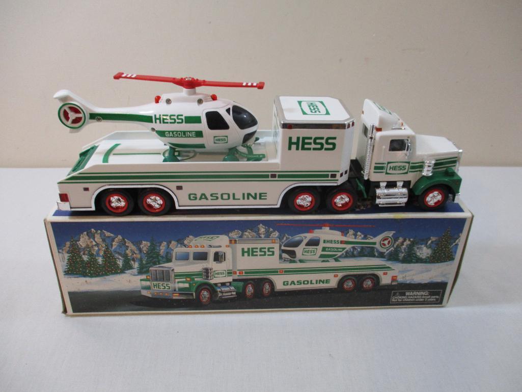 Two 1990s Hess Trucks including 1995 Toy Truck and Helicopter and 1997 Toy Truck and Racers, in