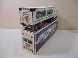 Two 1990s Hess Trucks including 1995 Toy Truck and Helicopter and 1997 Toy Truck and Racers, in