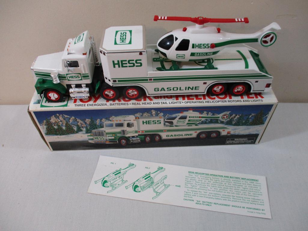 Two 1990s Hess Trucks including 1995 Toy Truck and Helicopter and 1997 Toy Truck and Racers, in