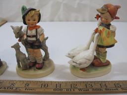 Four Hummel Figurines, Girl with Doll, Shepard Boy with Lambsm Girl with Geese and Kids with Basket