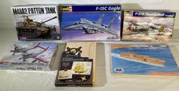 Model kits: (2) Revell planes, (2) Monogram tank & wood aircraft carrier, pirate ship