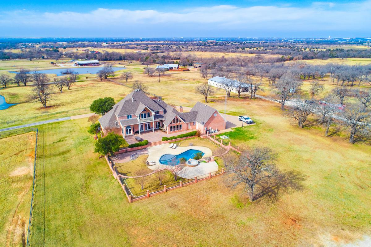 Tract 1: Executive Home w/heated pool, 11 stall show barn & pond on 15 acres