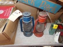 2 Antique, Dietz Lanterns, 1 Red, 1 Blue, On Table, (IN GARAGE)
