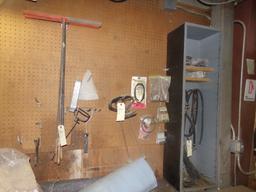 Group of Wheelbarrow Parts, Tires, Rims and Hand Sprayer Parts on Wall Over