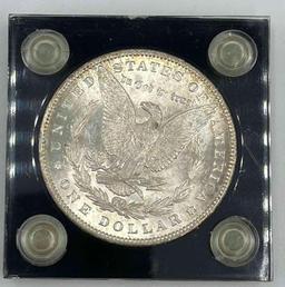 1890 Morgan Silver Dollar in Capital holder. AU