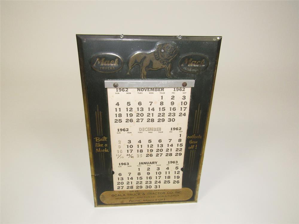 1950s Mack Trucks embossed metal dealership calendar with a 1962 calendar pad.