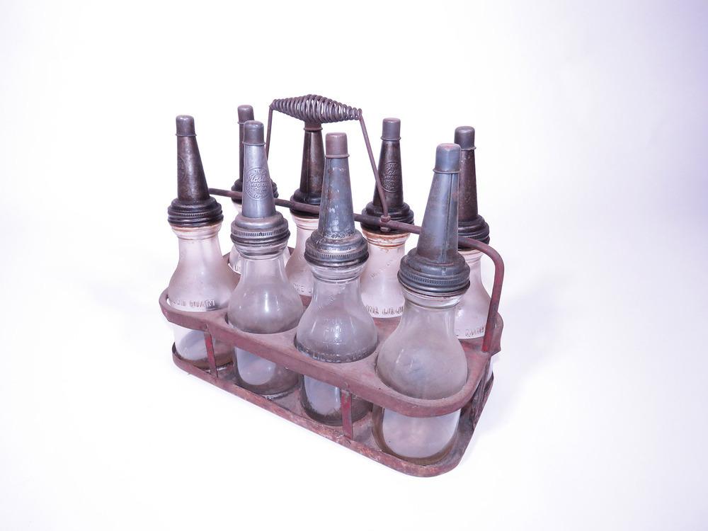 1930S PORTABLE BOTTLE RACK FILLED WITH GLASS OIL BOTTLES