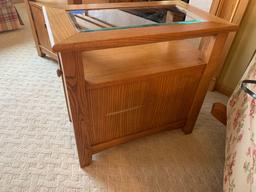 Glass top solid wood side table with door for storage.