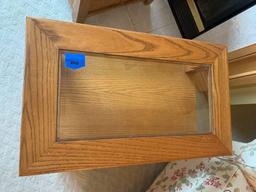 Glass top solid wood side table with door for storage.