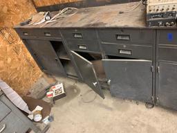 Approximately 10 foot tool bench with cabinets and drawers