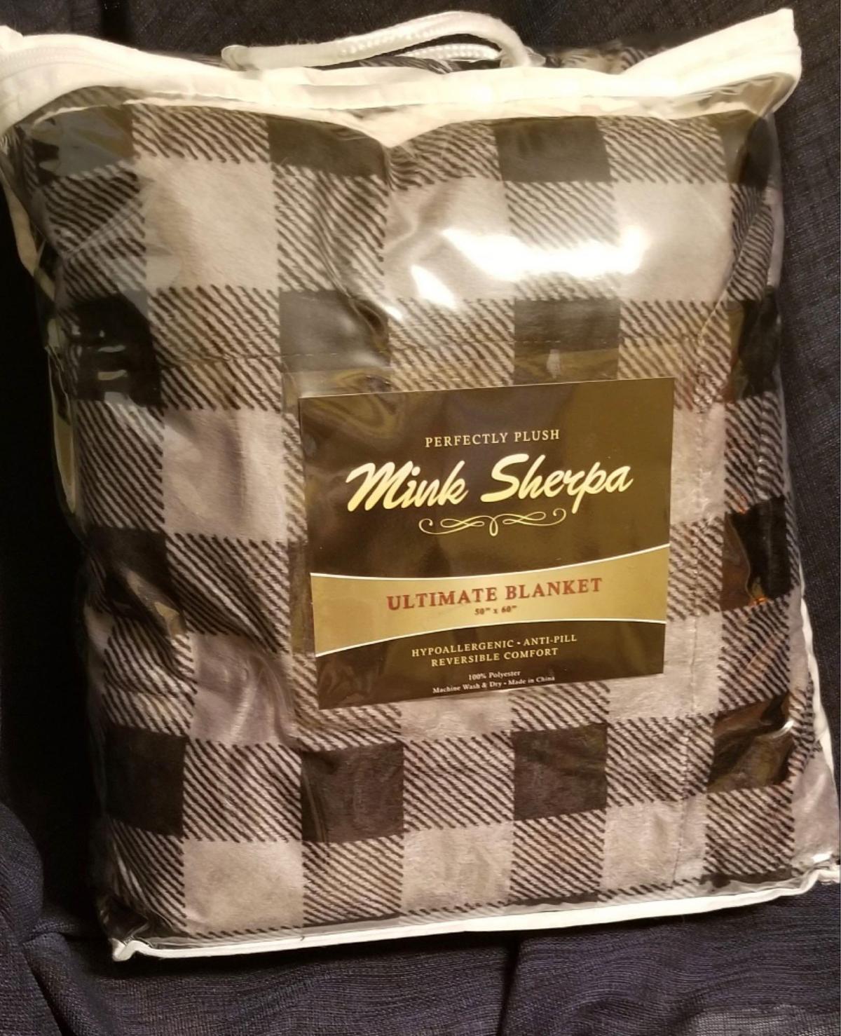 Plaid Reversible Mink Sherpa Blanket to cozy into by a warm fire Courtesy of Meraki Mama Boutique.