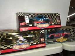 Three NASCAR stock cars new in box. Two Ertl. One American muscle. Dale Earnhardt and Richard petty