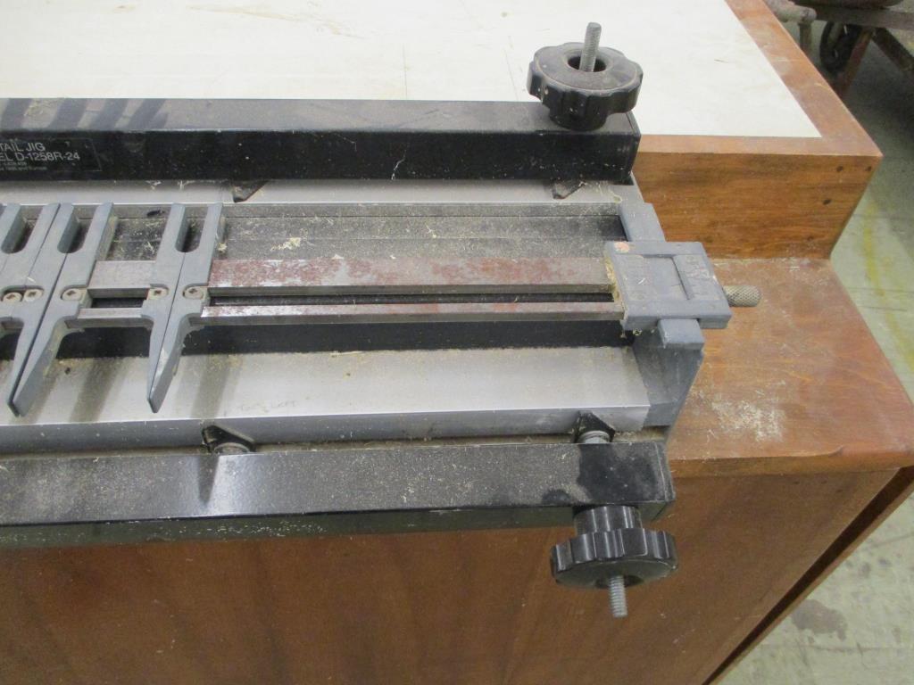 Leigh Industries Dovetail Jig on Wooden Cabinet.