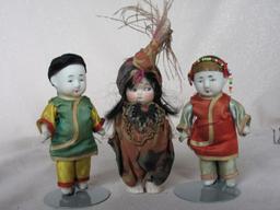 Three bisque cabinet figurines:- 9 5cm German Kewpie with painted features,
