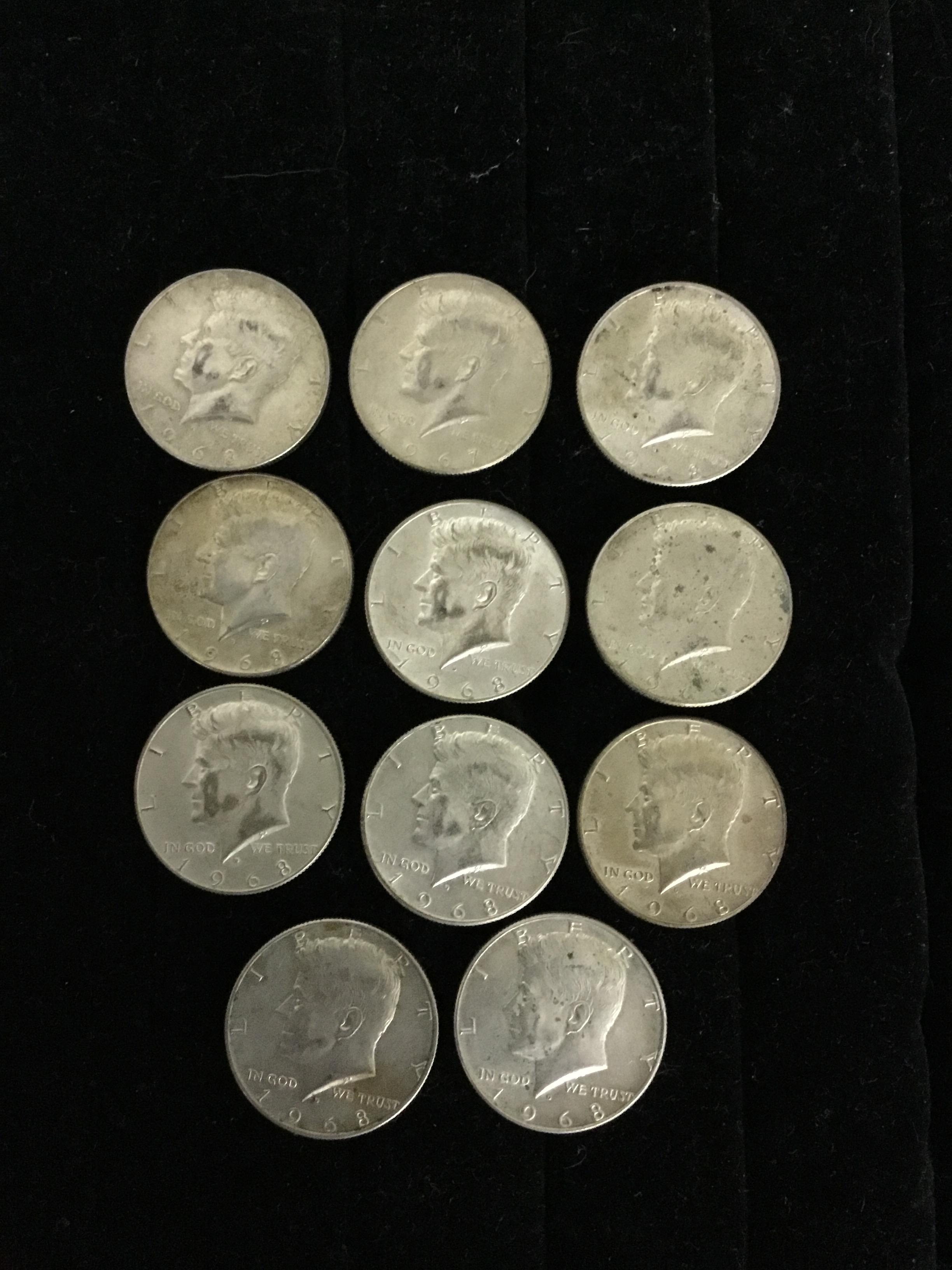 Eleven Kennedy half dollars