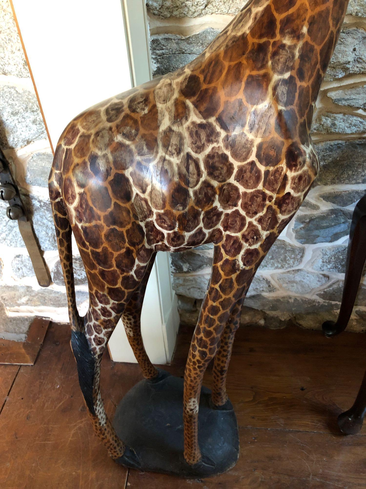 Wooden carved giraffe stands 61"� tall, excellent condition and detail