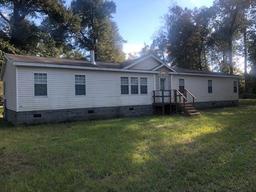 5.67 ACRES W/ 2560 SQ FT MANUFACTURED HOME, 12X16 SUNROOM,