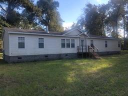 5.67 ACRES W/ 2560 SQ FT MANUFACTURED HOME, 12X16 SUNROOM,