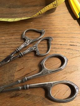 Two pairs antique Sterling Silver handled sewing scissors