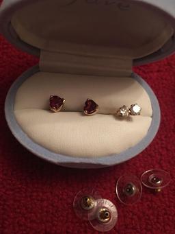 Two pairs 14k gold stud earrings. One clear, one red hearts